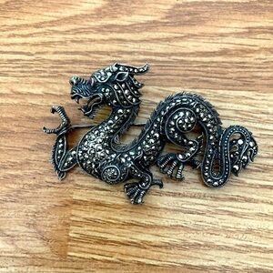 Dragon Brooch in Sterling Silver with Marcasite stones and a ruby looking eye..